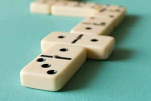Playing dominoes on a light background . The concept of the game of dominoes. Close up.