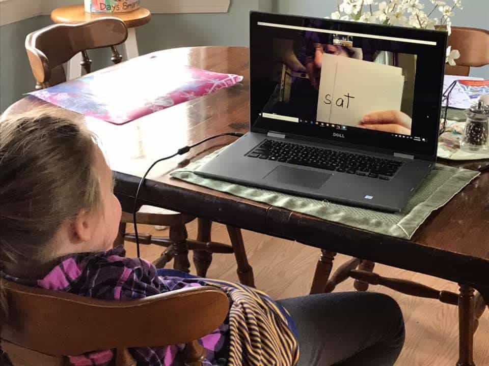 Grandmother using Zoom to review word families with Kindergarten student