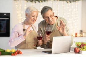 virtual New Year's Eve - Senior couple celebrating party with wine