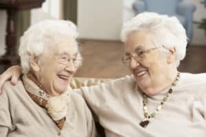 working in retirement - senior friend helping another senior