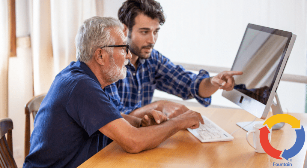 Caregiver assists client with computer