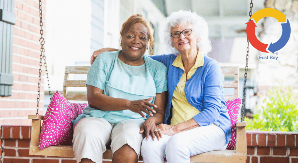 Senior companions enjoying time together on a porch swing