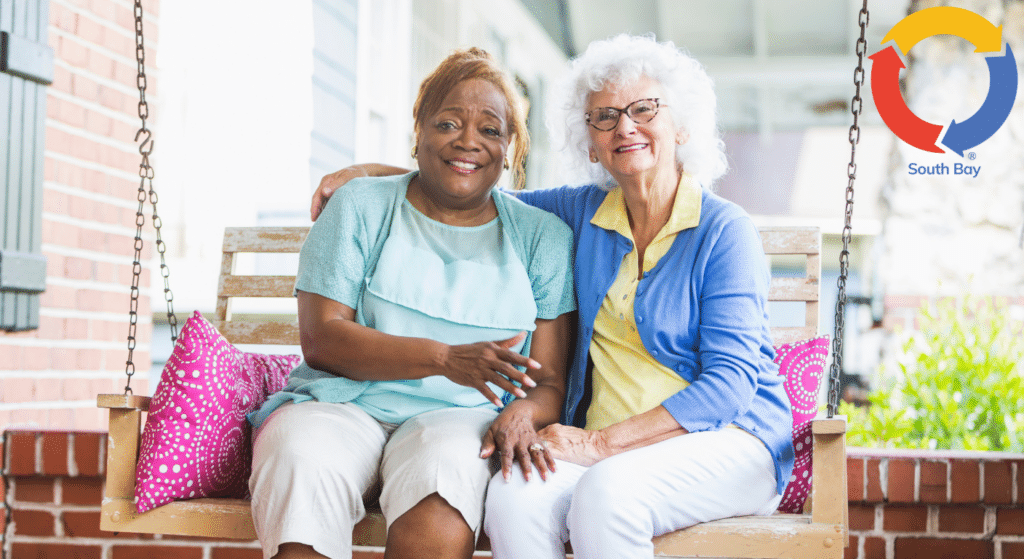 Senior companions enjoying time together on a porch swing